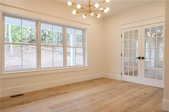 757 Cooper Rd, Glocester, RI 02814 - unfurnished room with plenty of natural light, french doors, light wood-style floors, and a chandelier