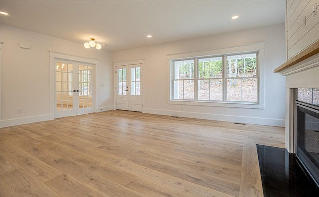 757 Cooper Rd, Glocester, RI 02814 - unfurnished living room with baseboards, light wood-type flooring, french doors, recessed lighting, and a tile fireplace