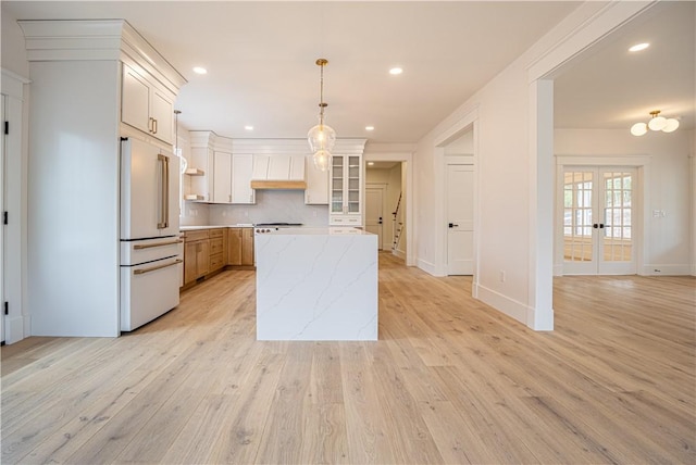 757 Cooper Rd, Glocester, RI 02814 - kitchen featuring high end white fridge, light wood-type flooring, a center island, tasteful backsplash, and french doors