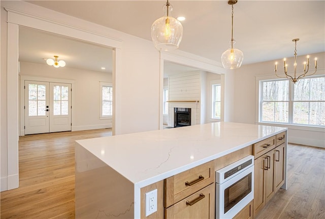 757 Cooper Rd, Glocester, RI 02814 - kitchen with built in microwave, open floor plan, light wood finished floors, a fireplace, and baseboards