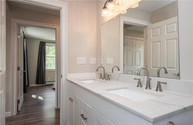 126 Hilton St, Tiverton, RI 02878 - bathroom with double vanity, wood finished floors, baseboards, and baseboard heating