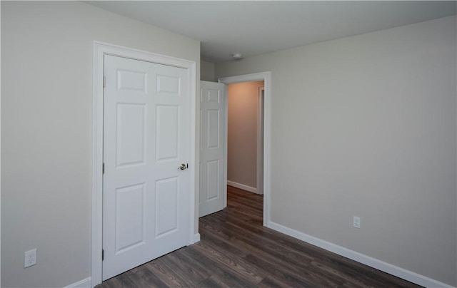 126 Hilton St, Tiverton, RI 02878 - unfurnished bedroom with dark wood-style floors and baseboards