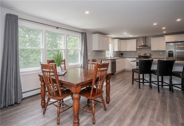 126 Hilton St, Tiverton, RI 02878 - dining area with plenty of natural light, dark wood-style flooring, recessed lighting, and baseboard heating