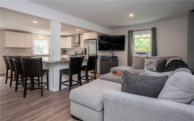 126 Hilton St, Tiverton, RI 02878 - living room featuring wood finished floors, recessed lighting, and decorative columns