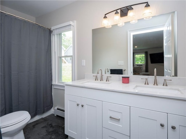 126 Hilton St, Tiverton, RI 02878 - full bath with a baseboard heating unit, double vanity, toilet, and healthy amount of natural light