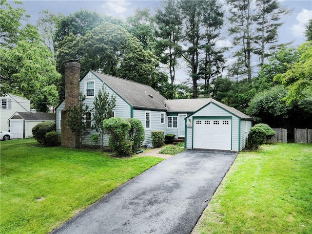 15 Franconia Dr, Cranston, RI 02920 - view of front of house featuring asphalt driveway, a chimney, a garage, and a shingled roof