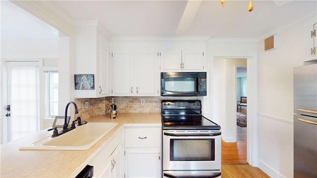 15 Franconia Dr, Cranston, RI 02920 - kitchen with stainless steel appliances, a sink, light countertops, tasteful backsplash, and light wood finished floors