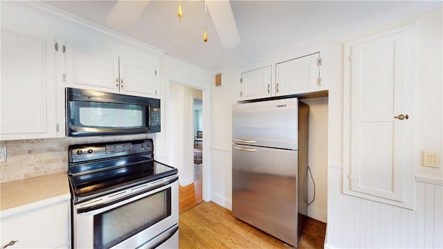 15 Franconia Dr, Cranston, RI 02920 - kitchen with stainless steel appliances, white cabinets, light wood-style flooring, light countertops, and ornamental molding