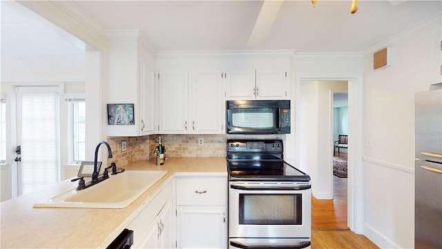 15 Franconia Dr, Cranston, RI 02920 - kitchen featuring appliances with stainless steel finishes, a sink, light countertops, decorative backsplash, and white cabinetry
