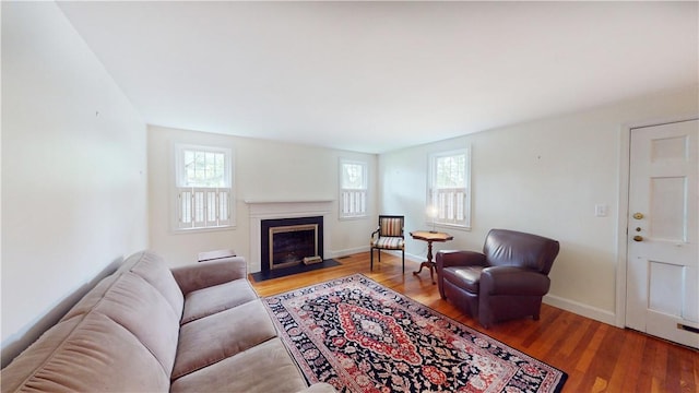 15 Franconia Dr, Cranston, RI 02920 - living area with wood finished floors, a fireplace with flush hearth, and baseboards