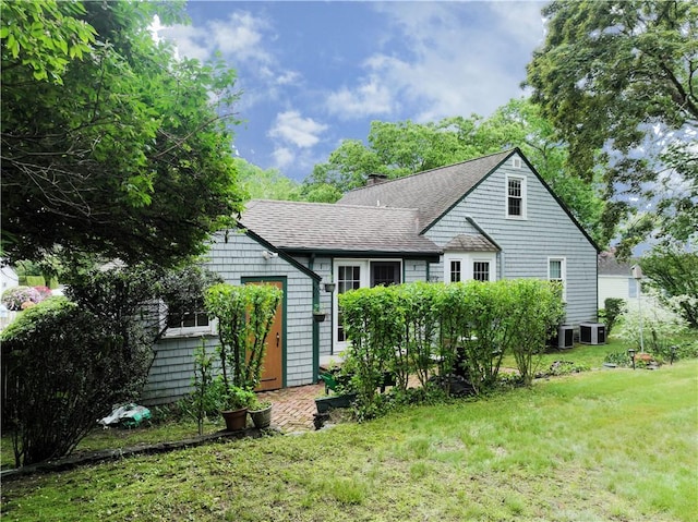 15 Franconia Dr, Cranston, RI 02920 - back of house featuring a yard, central AC, a chimney, and roof with shingles