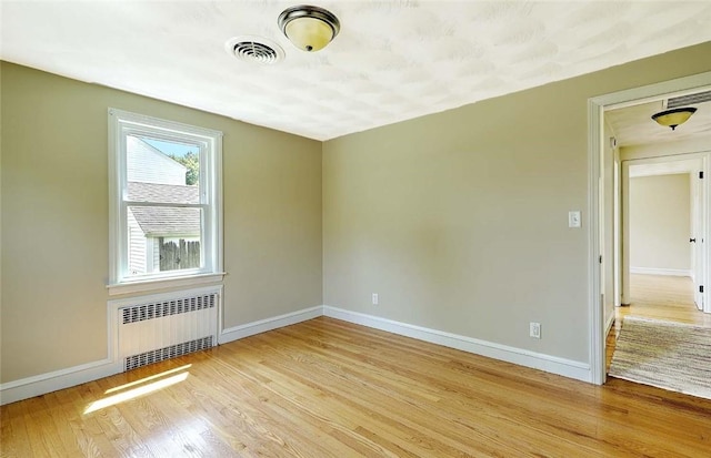 23 Robert Cir, Cranston, RI 02905 - spare room with radiator heating unit, wood finished floors, and baseboards