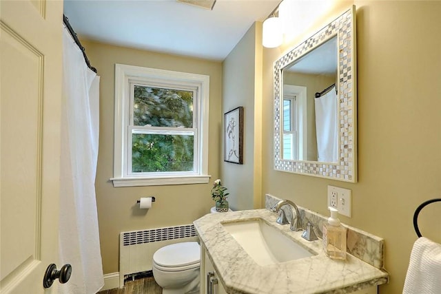 23 Robert Cir, Cranston, RI 02905 - full bathroom featuring radiator, vanity, toilet, and wood finished floors