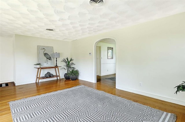 23 Robert Cir, Cranston, RI 02905 - living area with arched walkways, wood finished floors, and baseboards