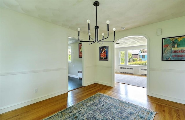 23 Robert Cir, Cranston, RI 02905 - unfurnished dining area featuring radiator heating unit, wood finished floors, and plenty of natural light