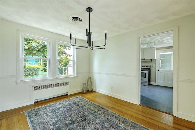 23 Robert Cir, Cranston, RI 02905 - dining space with radiator, a chandelier, wood finished floors, and baseboards