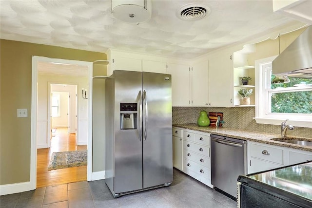 23 Robert Cir, Cranston, RI 02905 - kitchen with stainless steel appliances, a sink, white cabinets, and backsplash