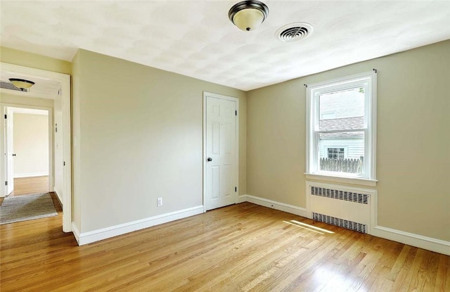 23 Robert Cir, Cranston, RI 02905 - empty room featuring radiator heating unit, light wood-style floors, and baseboards
