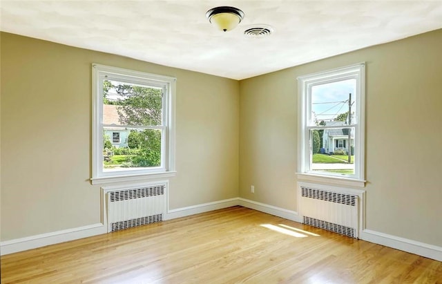 23 Robert Cir, Cranston, RI 02905 - spare room featuring radiator, wood finished floors, and baseboards
