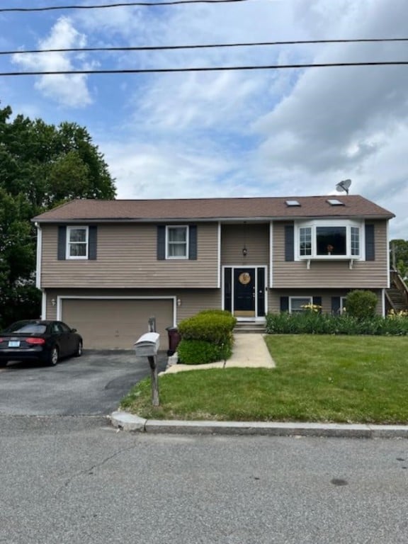 80 Capwell Ave, Woonsocket, RI 02895 - split foyer home featuring a garage, driveway, and a front yard