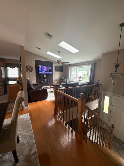 80 Capwell Ave, Woonsocket, RI 02895 - hallway with an upstairs landing, a skylight, wood-type flooring, and vaulted ceiling