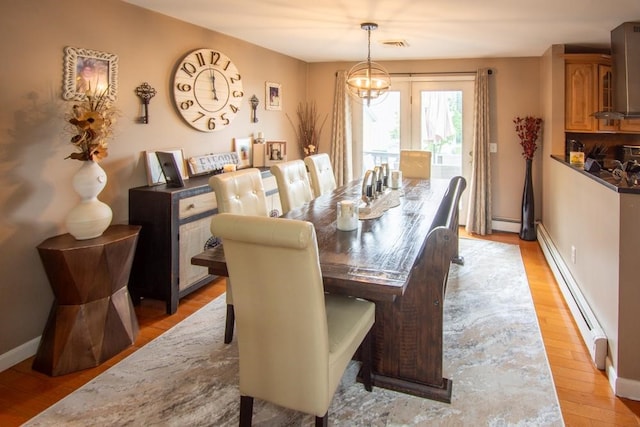 80 Capwell Ave, Woonsocket, RI 02895 - dining room featuring light wood-style floors, a baseboard heating unit, and baseboards