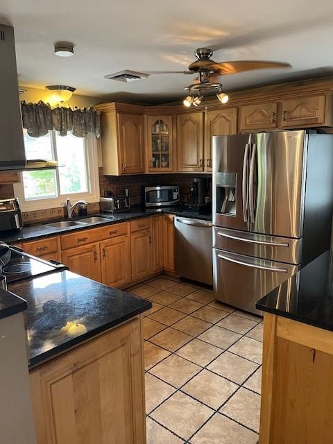 80 Capwell Ave, Woonsocket, RI 02895 - kitchen featuring stainless steel appliances, a sink, light tile patterned flooring, dark countertops, and backsplash