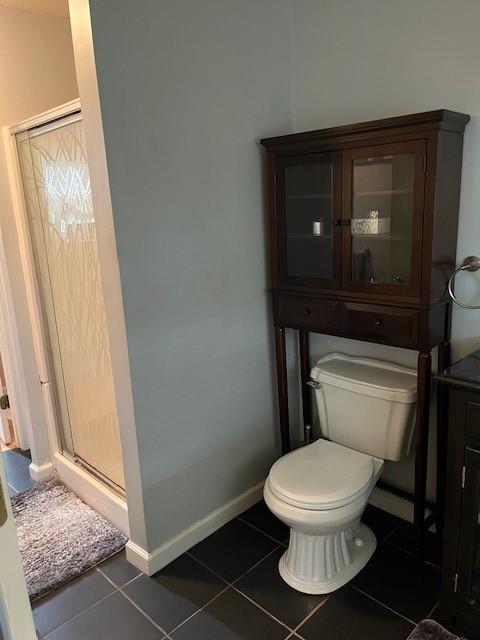 80 Capwell Ave, Woonsocket, RI 02895 - full bathroom with tile patterned flooring, toilet, a stall shower, and baseboards