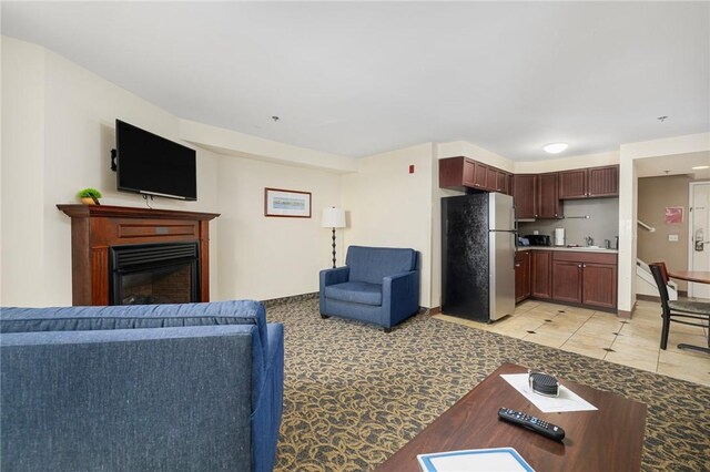 65 Ridge Rd Unit T11/W38, Newport, RI 02840 - living area featuring a glass covered fireplace, baseboards, and light tile patterned floors