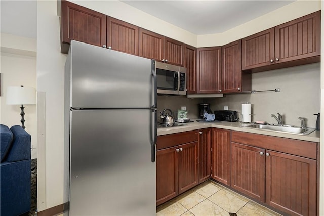 65 Ridge Rd Unit T11/W38, Newport, RI 02840 - kitchen featuring stainless steel appliances, a sink, light countertops, and light tile patterned floors