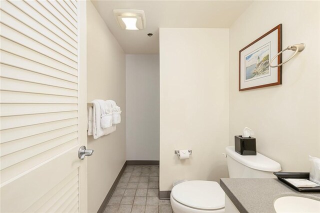 65 Ridge Rd Unit T11/W38, Newport, RI 02840 - half bathroom with toilet, baseboards, vanity, and tile patterned flooring