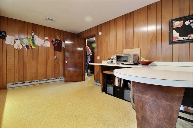 2 Laurel Hill Dr, Westerly, RI 02891 - kitchen with baseboard heating, brown cabinets, light countertops, and wood walls
