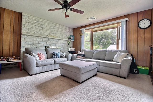 2 Laurel Hill Dr, Westerly, RI 02891 - carpeted living room featuring a ceiling fan, a textured ceiling, wooden walls, and a baseboard radiator