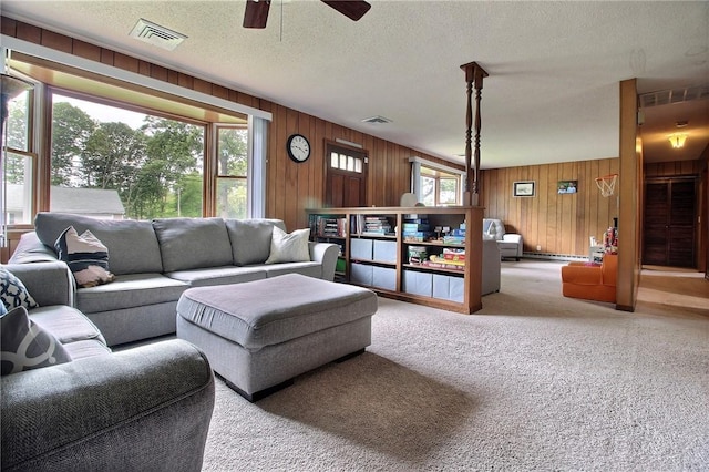2 Laurel Hill Dr, Westerly, RI 02891 - carpeted living area featuring wooden walls, ceiling fan, and a textured ceiling