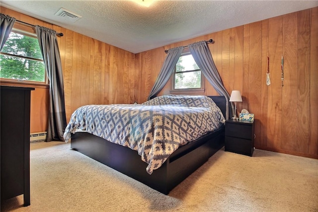 2 Laurel Hill Dr, Westerly, RI 02891 - carpeted bedroom featuring baseboard heating, a textured ceiling, wooden walls, and multiple windows