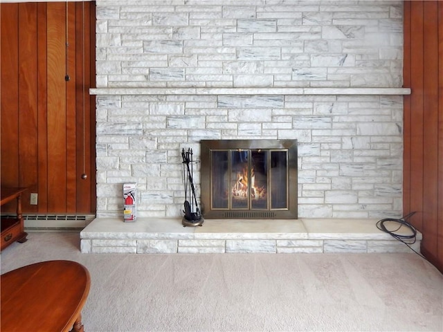 2 Laurel Hill Dr, Westerly, RI 02891 - detailed view of a baseboard heating unit, carpet, a stone fireplace, and a fire extinguisher