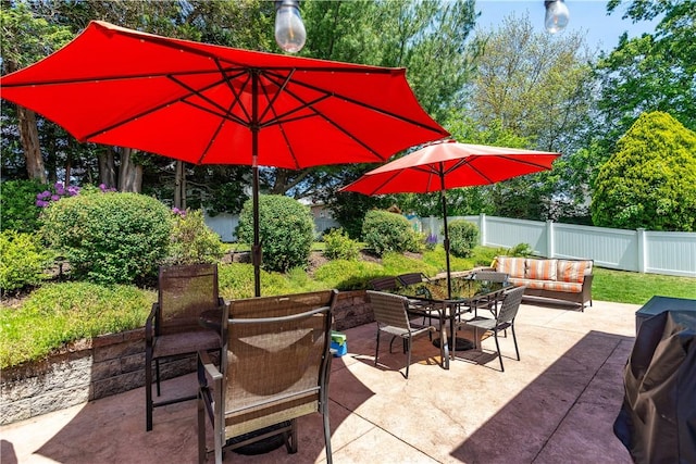 59 Davis Ave, Cranston, RI 02910 - fenced backyard featuring outdoor dining area, a patio area, outdoor lounge area, and view of scattered trees