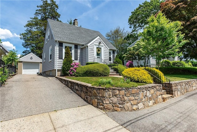 59 Davis Ave, Cranston, RI 02910 - view of front of home with a garage, a chimney, an outbuilding, a shingled roof, and asphalt driveway