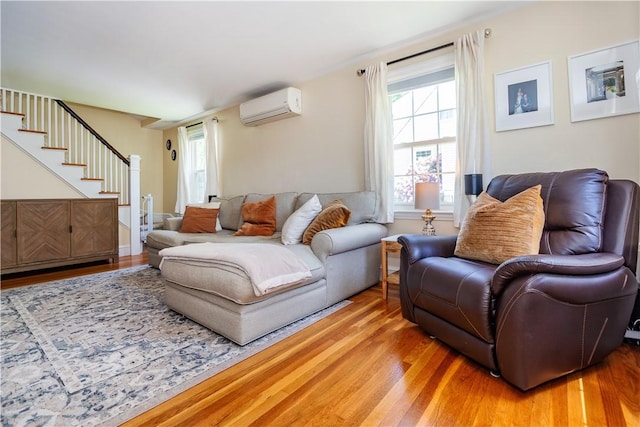 59 Davis Ave, Cranston, RI 02910 - living area with a wall unit AC, wood finished floors, and stairs