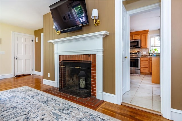 59 Davis Ave, Cranston, RI 02910 - detailed view of stainless steel appliances, a fireplace, wood finished floors, and baseboards