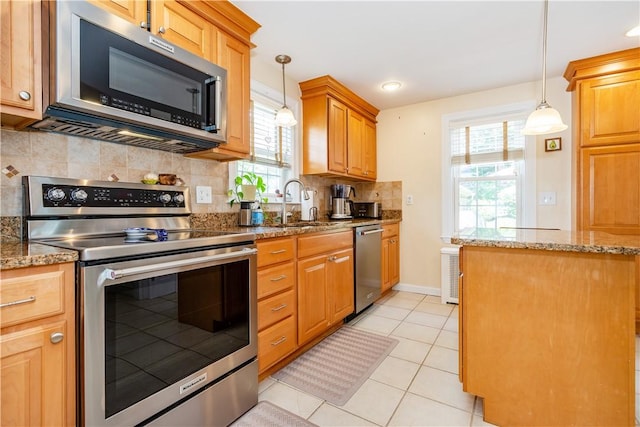 59 Davis Ave, Cranston, RI 02910 - kitchen featuring stainless steel appliances, tasteful backsplash, light stone counters, light tile patterned flooring, and pendant lighting