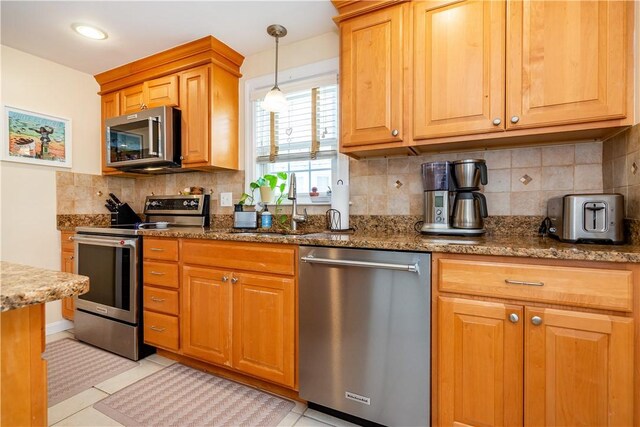 59 Davis Ave, Cranston, RI 02910 - kitchen with appliances with stainless steel finishes, a sink, dark stone countertops, hanging light fixtures, and tasteful backsplash