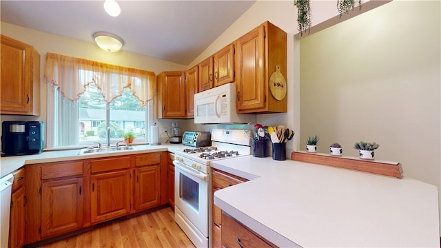 127 Pleasant View Ave Unit 34, Smithfield, RI 02917 - kitchen featuring white appliances, vaulted ceiling, brown cabinets, light countertops, and light wood finished floors