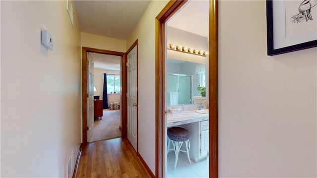 127 Pleasant View Ave Unit 34, Smithfield, RI 02917 - corridor with light wood-style floors and a sink