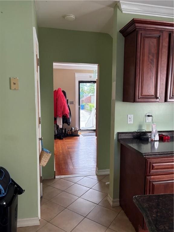 15 Villa Ave, Cranston, RI 02905 - kitchen with dark countertops, light tile patterned floors, baseboards, and reddish brown cabinets
