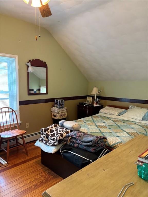 15 Villa Ave, Cranston, RI 02905 - bedroom with wood finished floors, vaulted ceiling, and a baseboard heating unit