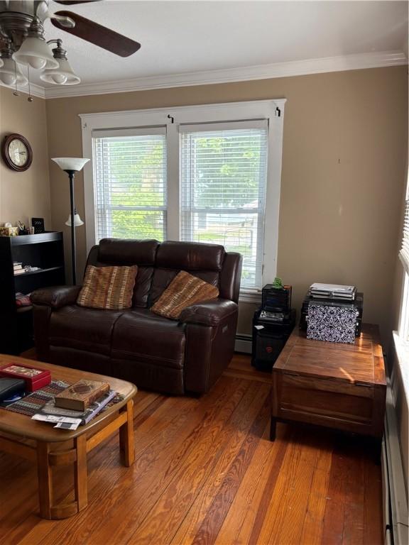 15 Villa Ave, Cranston, RI 02905 - living room featuring ceiling fan, healthy amount of natural light, a baseboard heating unit, crown molding, and light wood-style floors