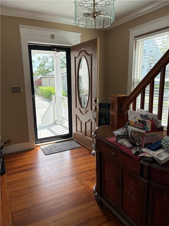 15 Villa Ave, Cranston, RI 02905 - entryway featuring ornamental molding, a chandelier, and light wood-style floors