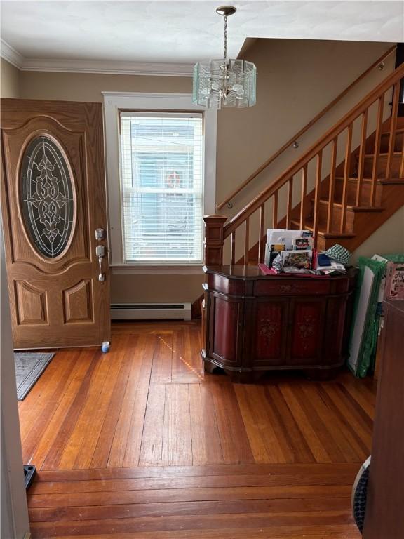 15 Villa Ave, Cranston, RI 02905 - entryway featuring a baseboard radiator, stairway, a chandelier, hardwood / wood-style floors, and ornamental molding