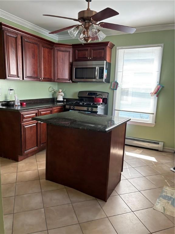 15 Villa Ave, Cranston, RI 02905 - kitchen with stainless steel appliances, a baseboard radiator, ornamental molding, light tile patterned floors, and a ceiling fan